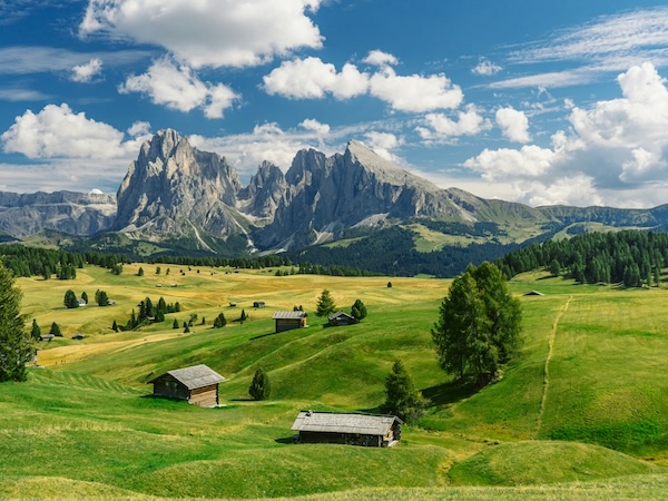 Mountain Majesty in the Dolomites – 2026 Dolomites Tour Panoramic view of the Dolomites with dramatic peaks and alpine meadows