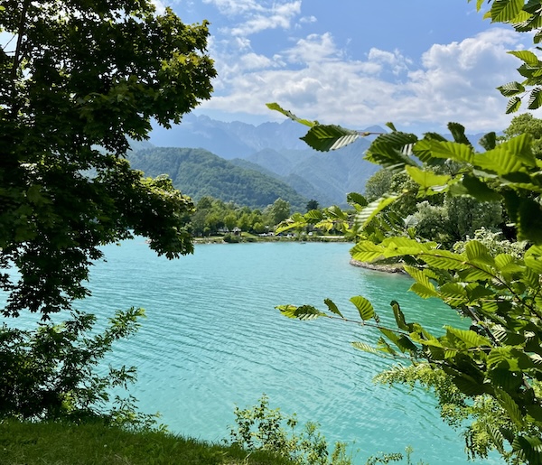 lake-barcis-friuli-tour-italian-tours Turquoise waters of Lake Barcis surrounded by forested mountains in Friuli Venezia Giulia.